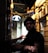 A man in a hat and glasses standing in an alley