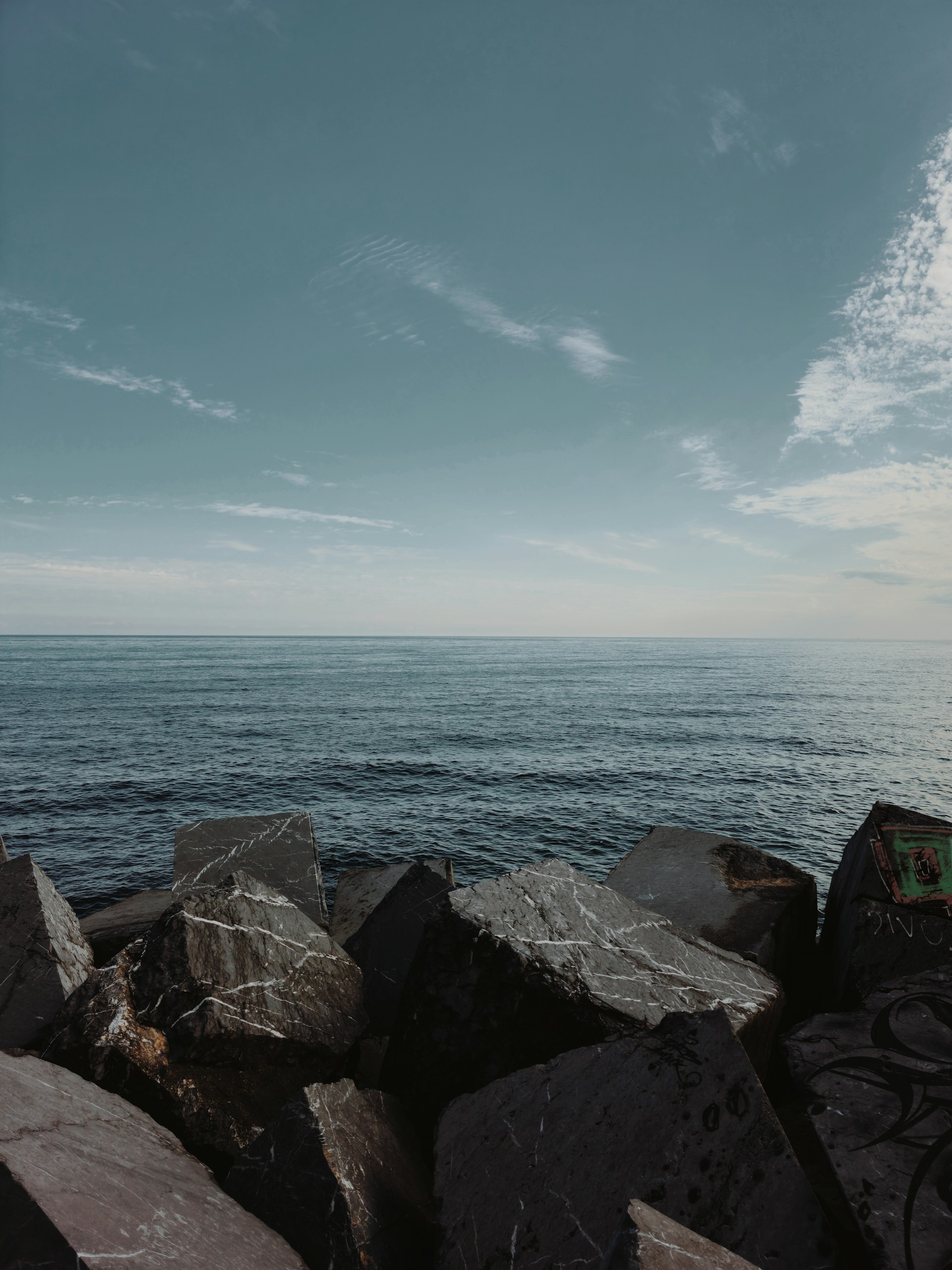 A man riding a bike on top of a rocky beach