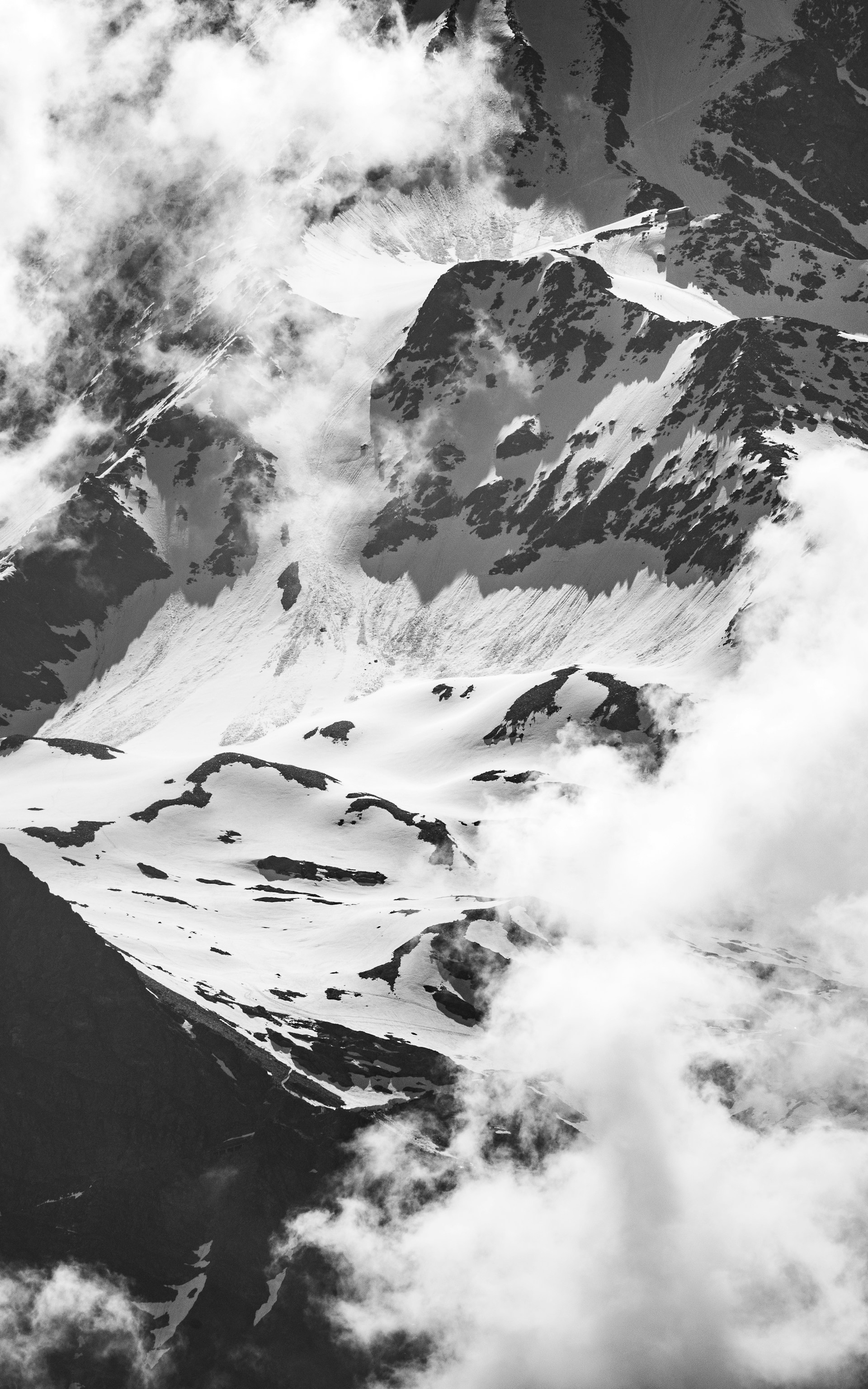 A black and white photo of a snow covered mountain