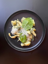 A plate of pasta with spinach and parmesan cheese