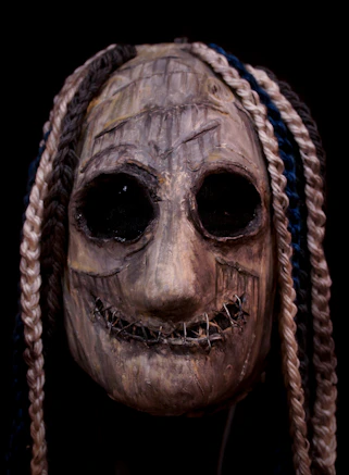 A creepy mask with braids on it