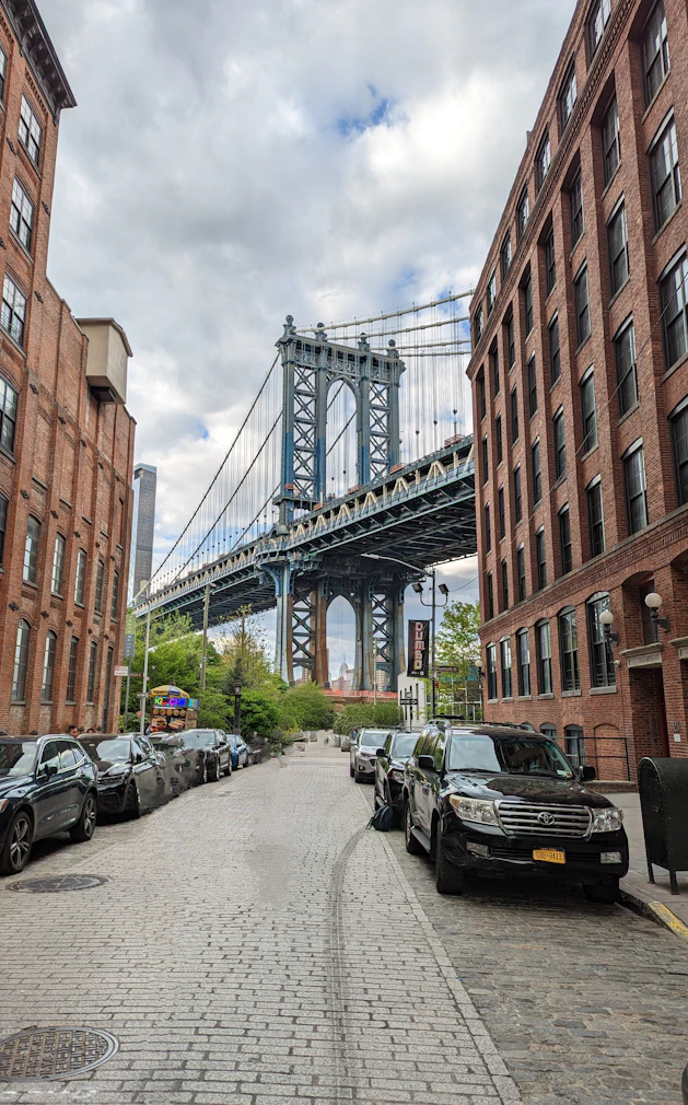 A city street with a bridge in the background