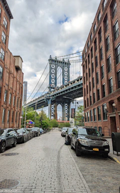 A city street with a bridge in the background