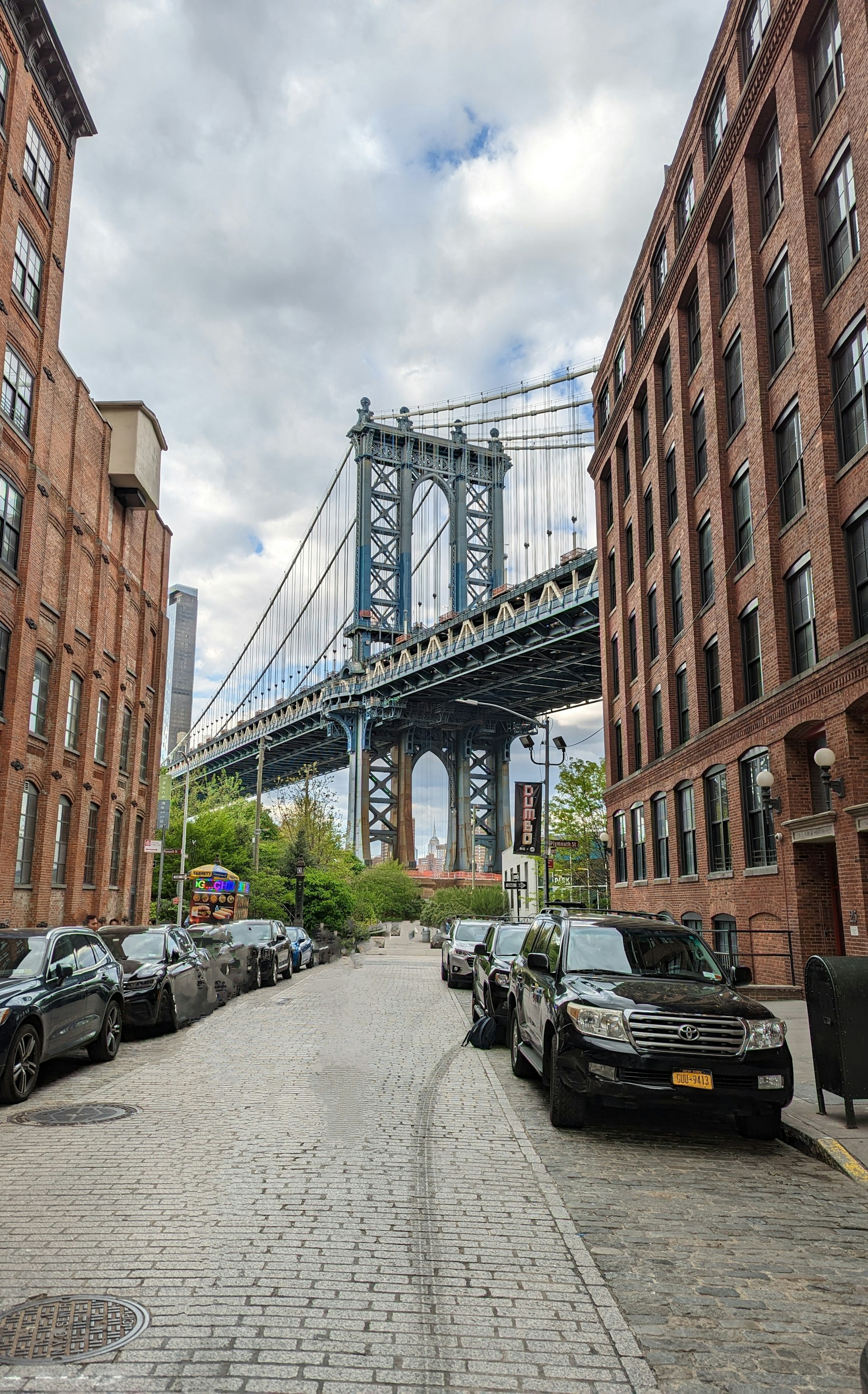 A city street with a bridge in the background