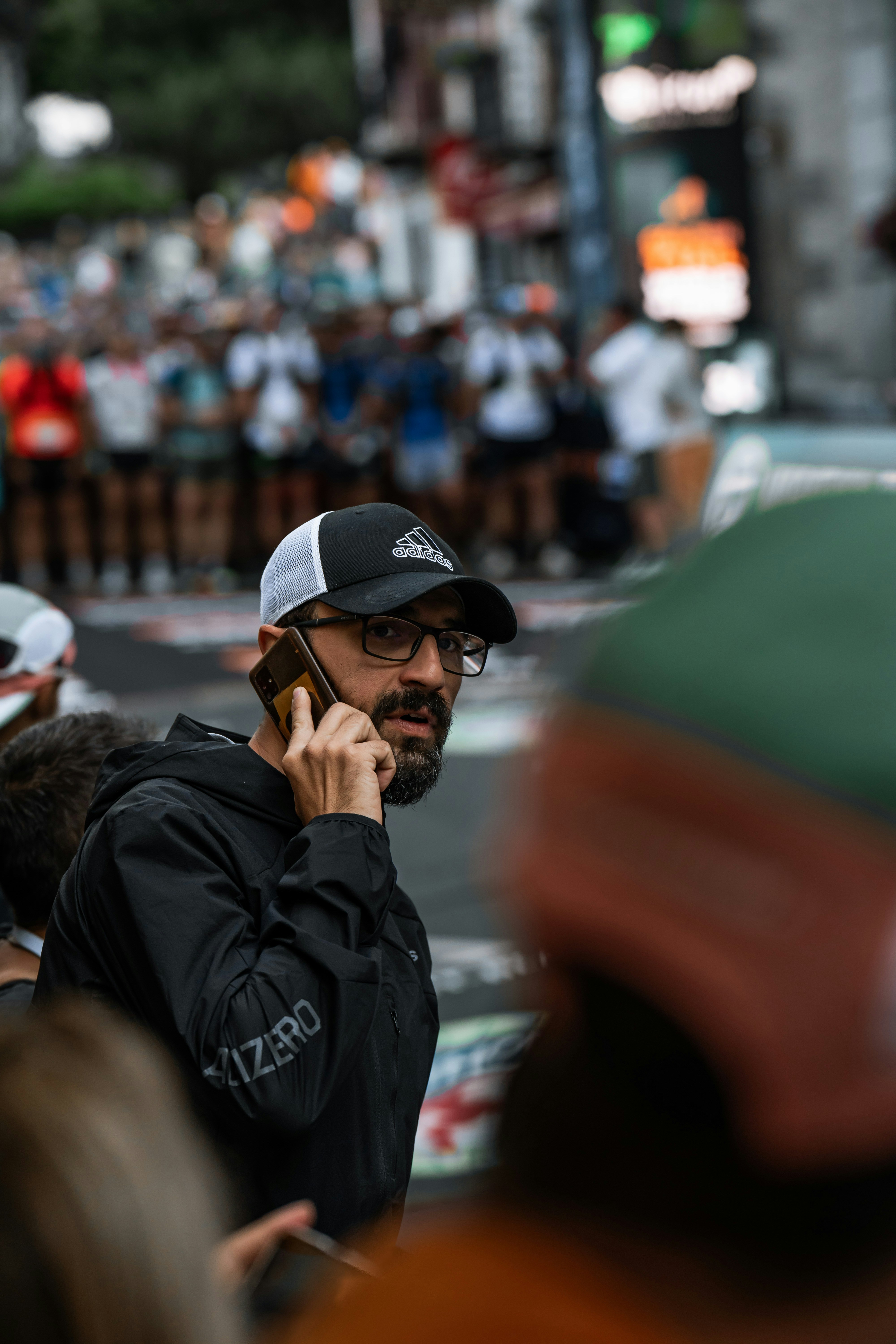 A man talking on a cell phone while standing in the street