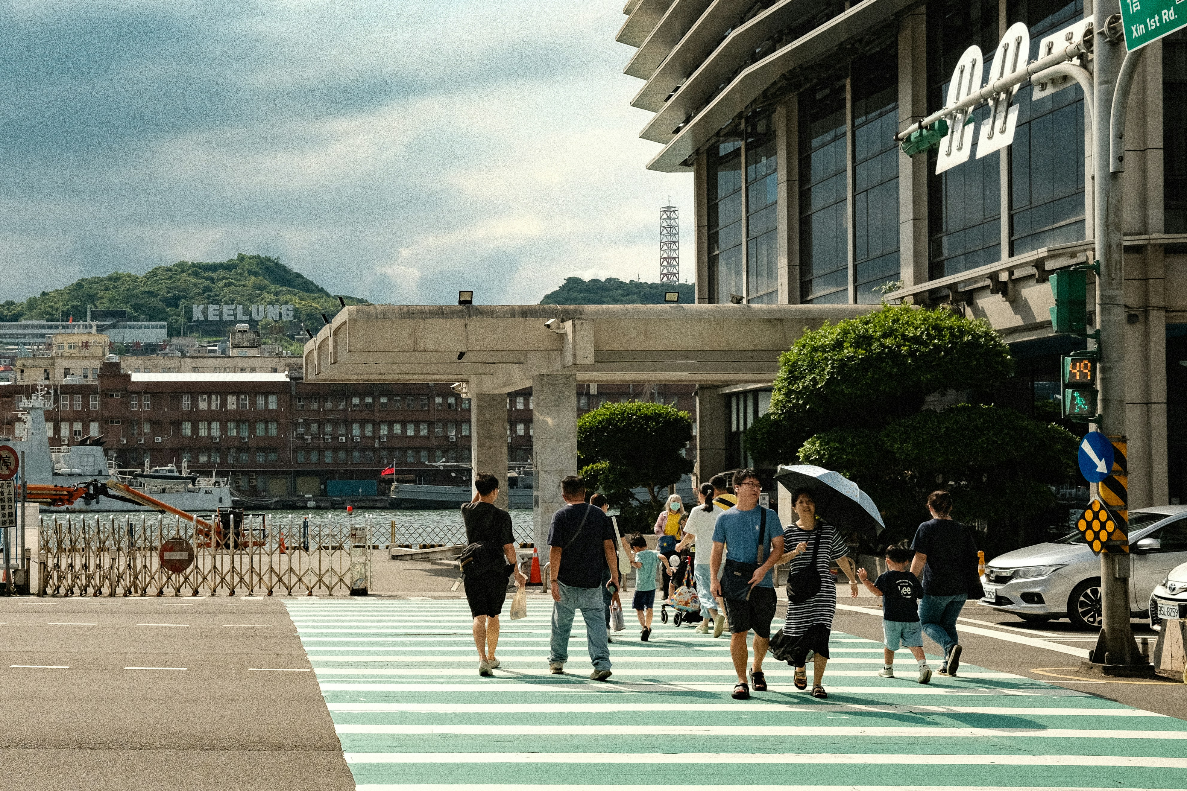 A group of people walking across a cross walk