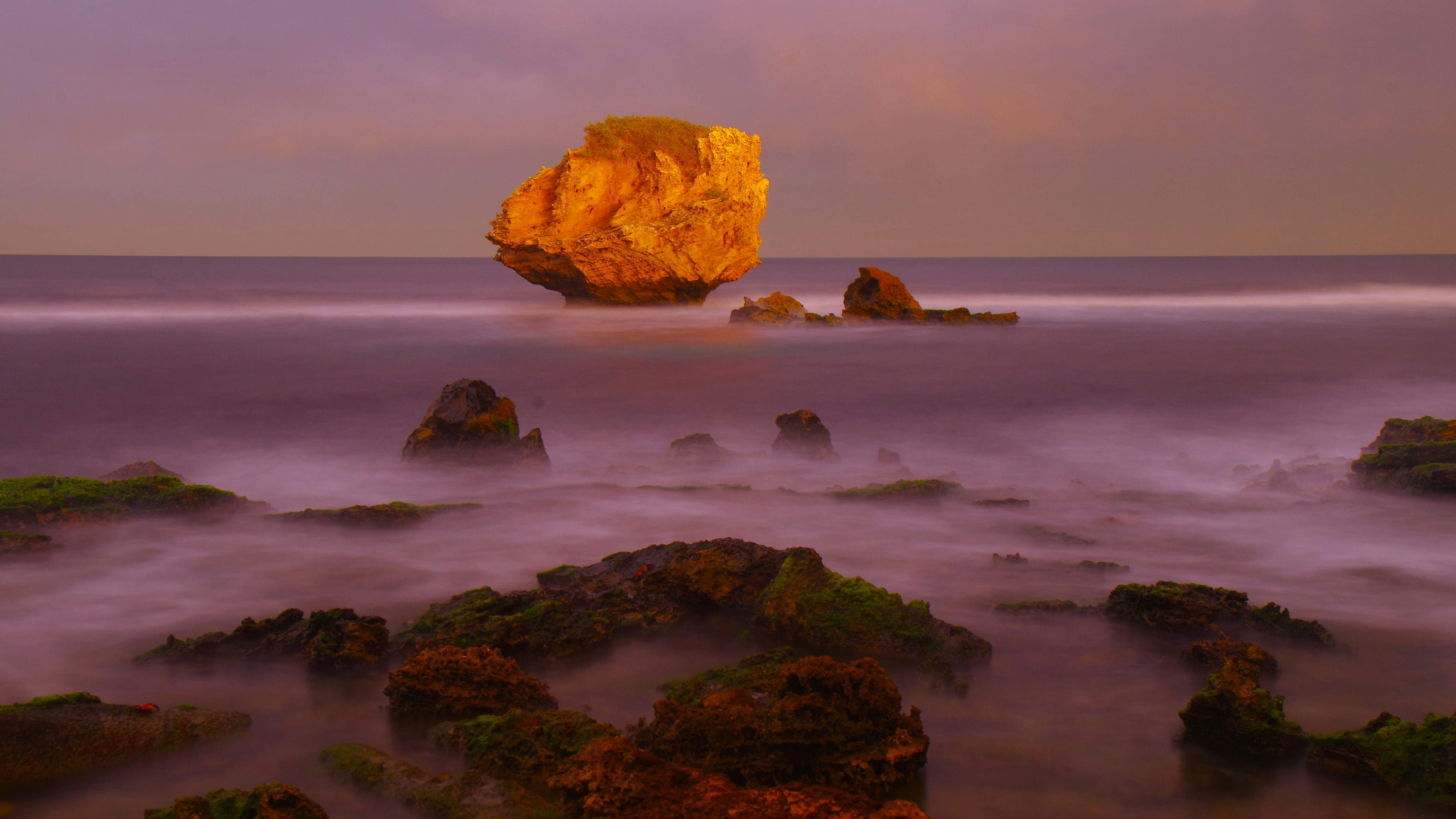 A large rock sticking out of the ocean