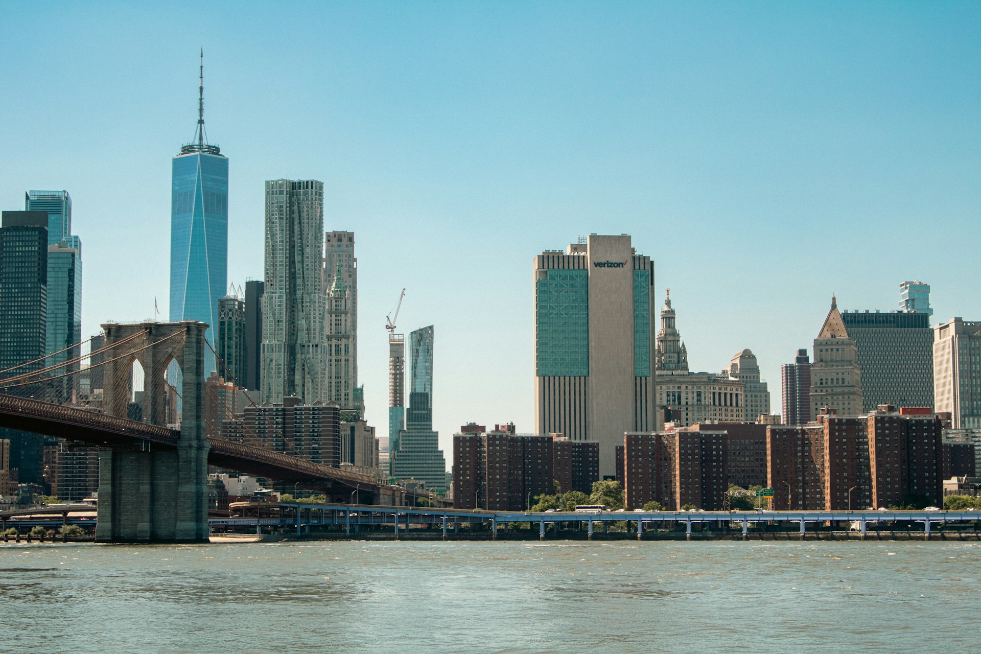 A view of a city with a bridge in the foreground