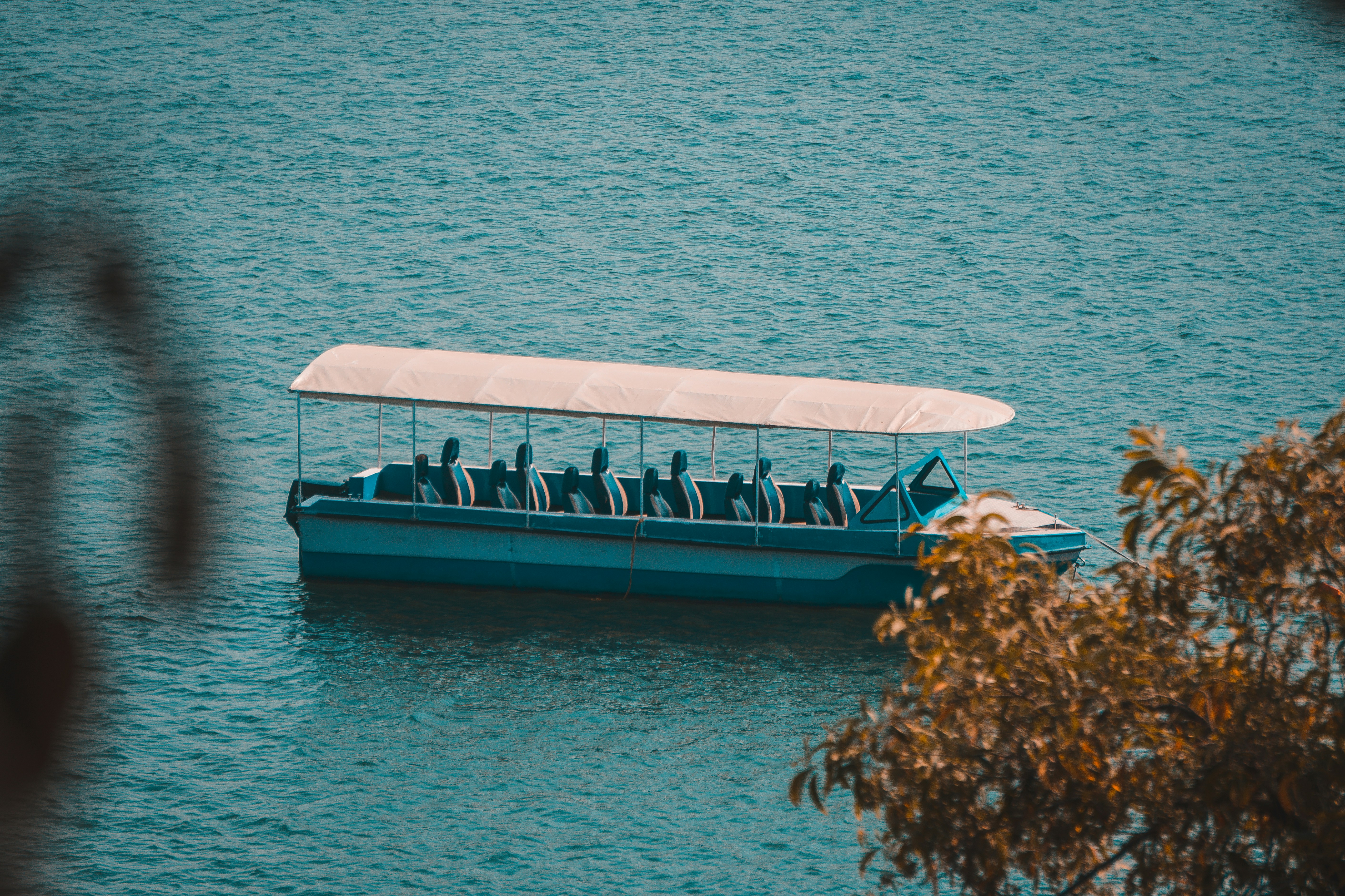A boat filled with people floating on top of a lake