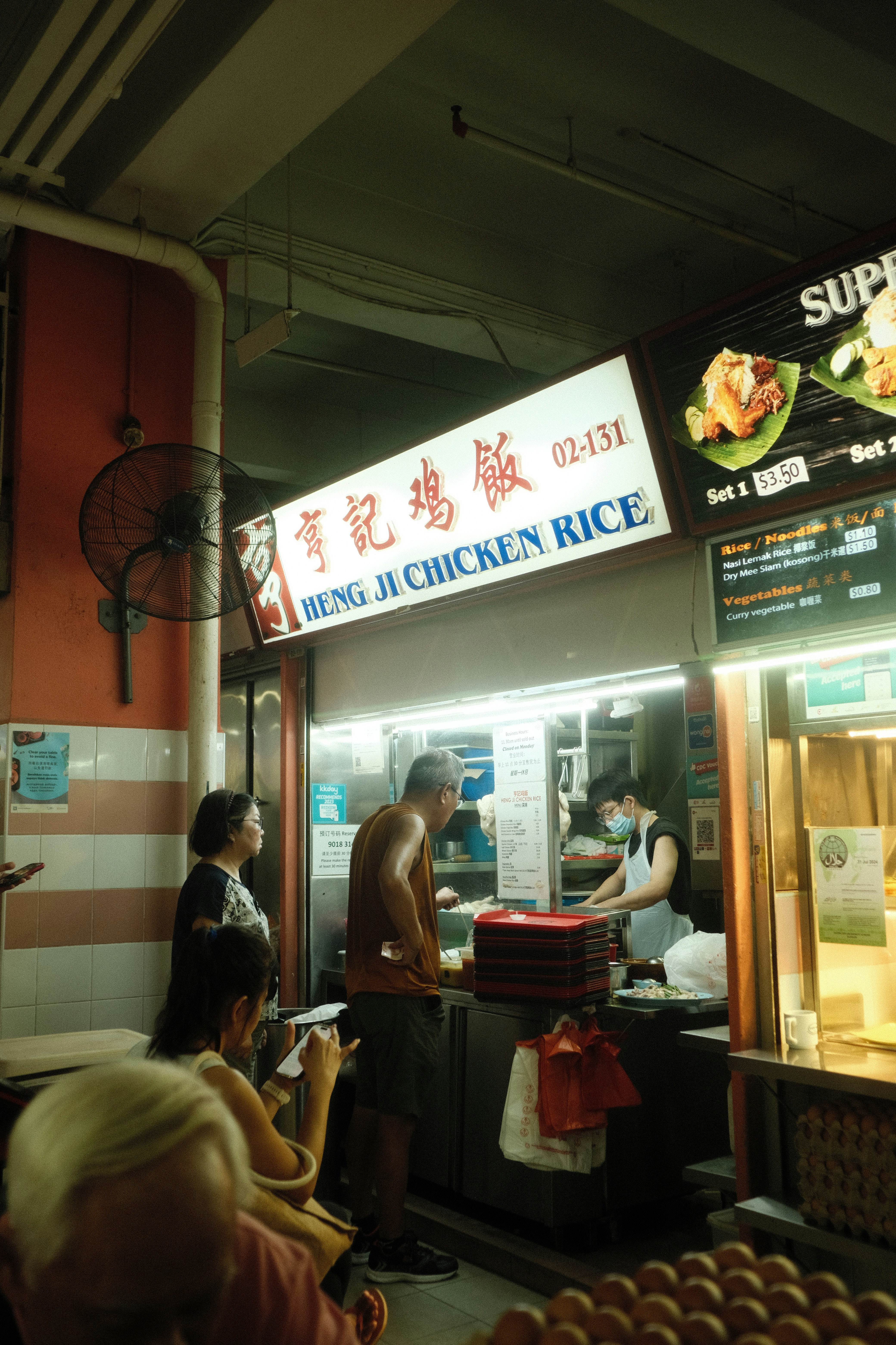 A group of people standing around a restaurant