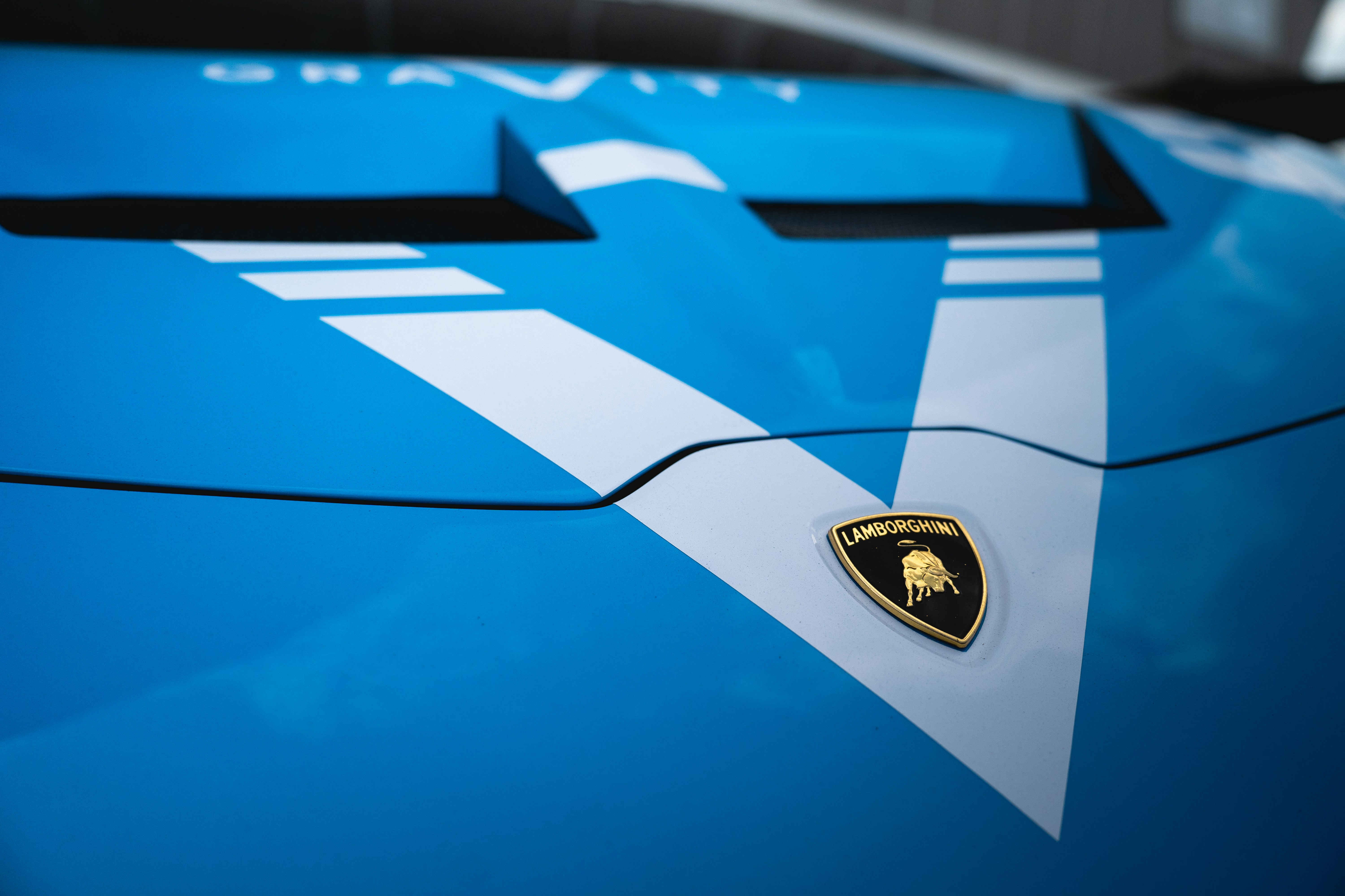 A close up of the hood of a blue sports car
