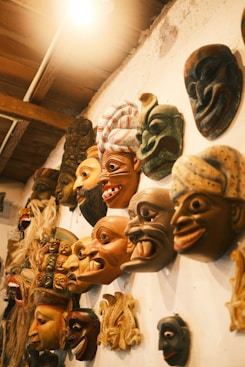 A group of masks hanging on a wall
