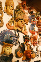 A wall covered in lots of different masks