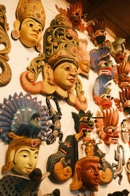 A wall covered in lots of different masks