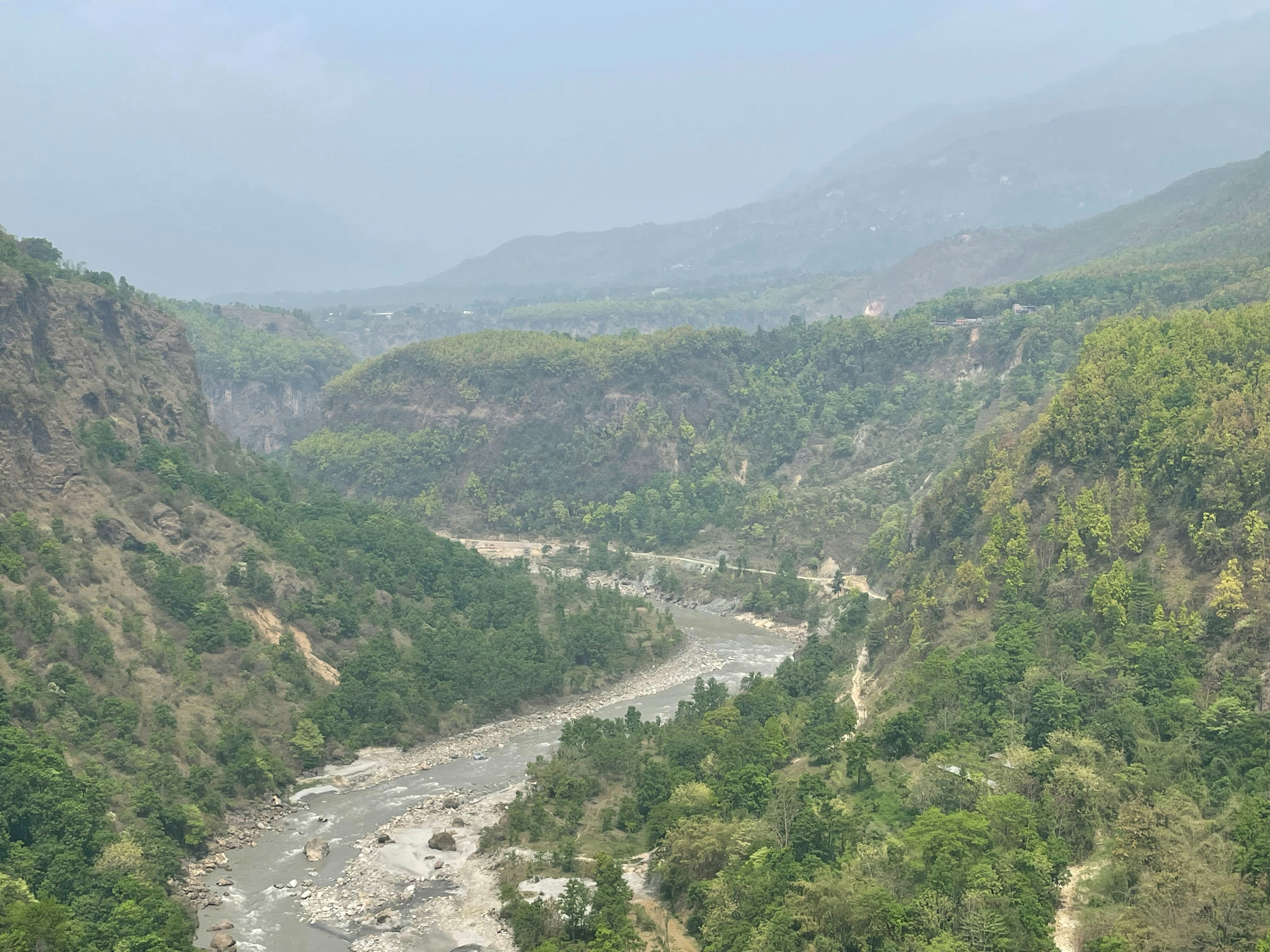 A river flowing through a lush green valley