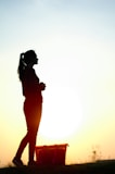 A woman standing on top of a grass covered field