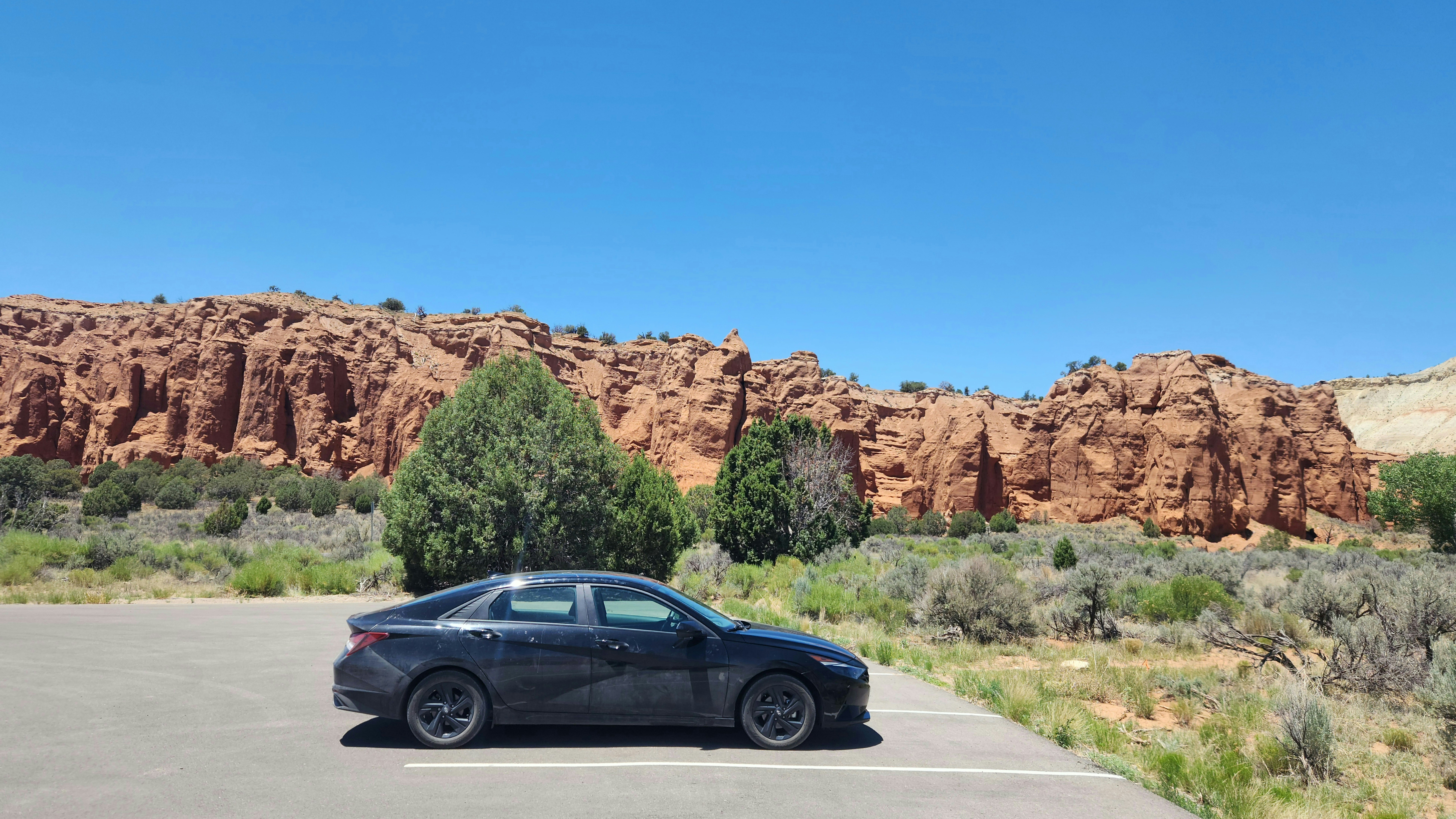 Family loading luggage into a three-row electric SUV for a road trip