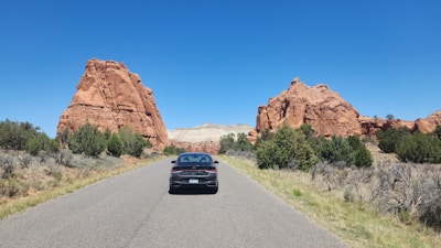 A car driving down a road in the desert