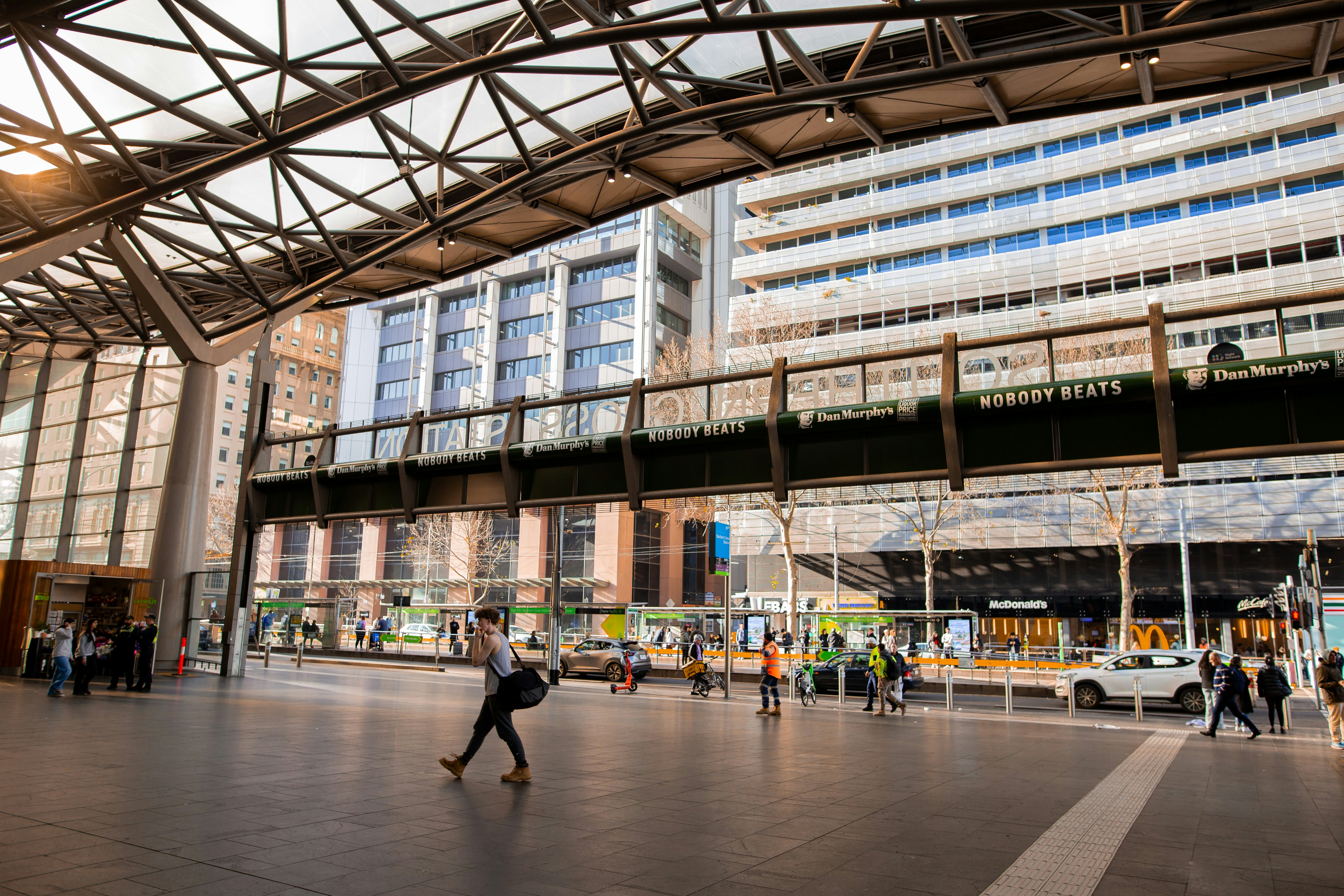 A group of people walking around a large building