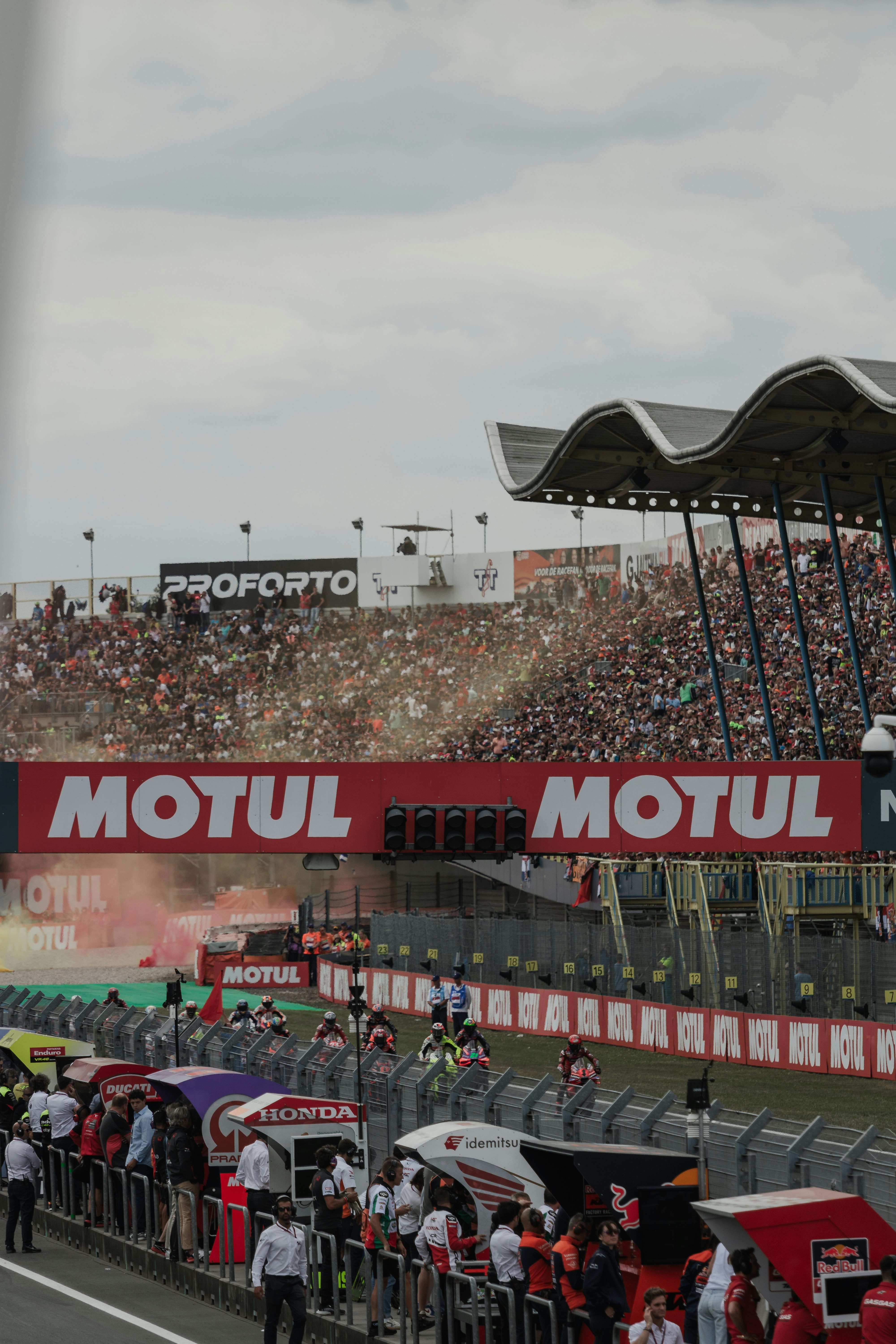 A crowd of people standing around a race track
