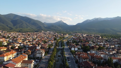 An aerial view of a city with mountains in the background