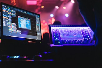 A person sitting in front of two computer monitors