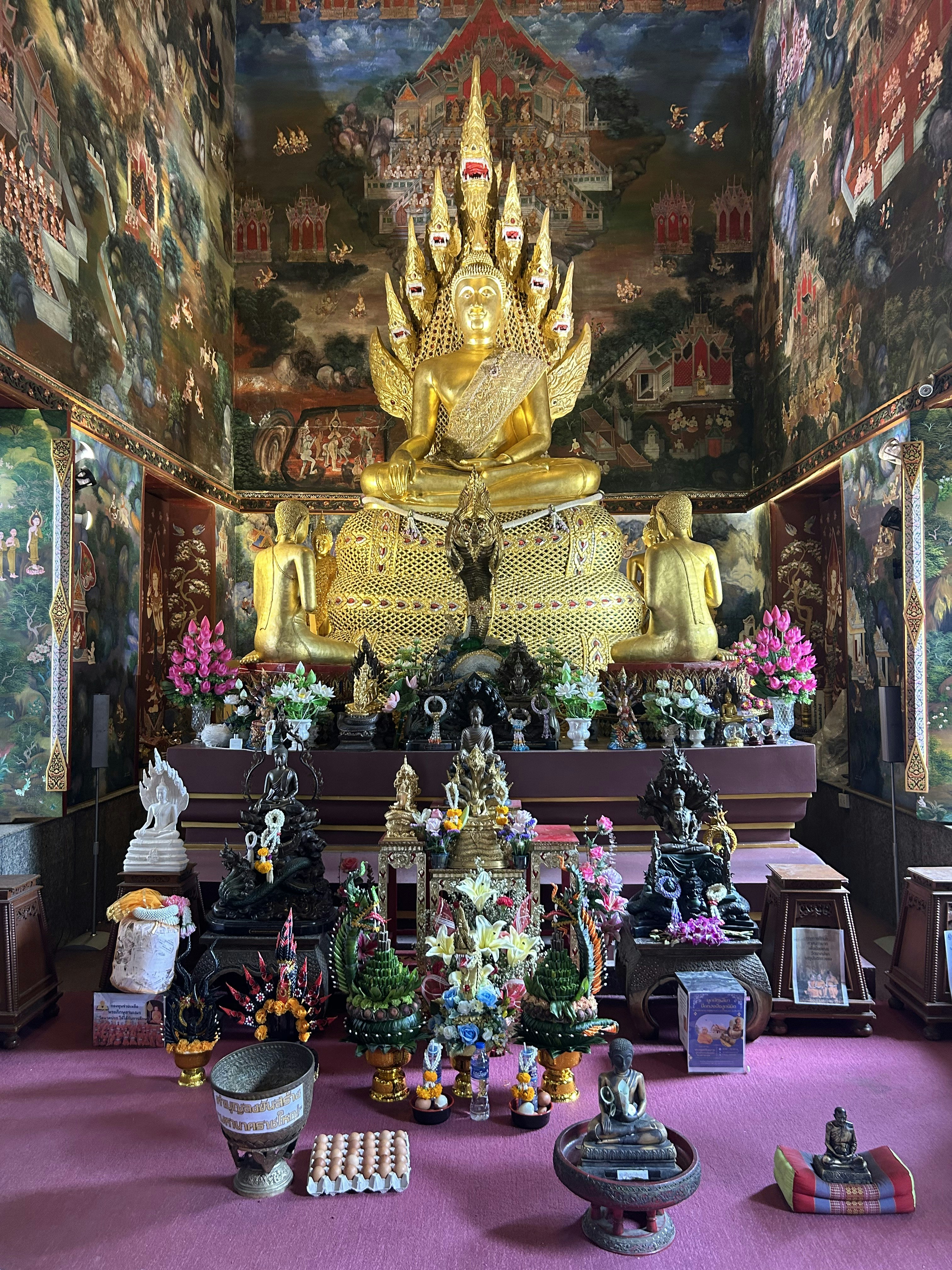 A large golden buddha statue sitting in the middle of a room