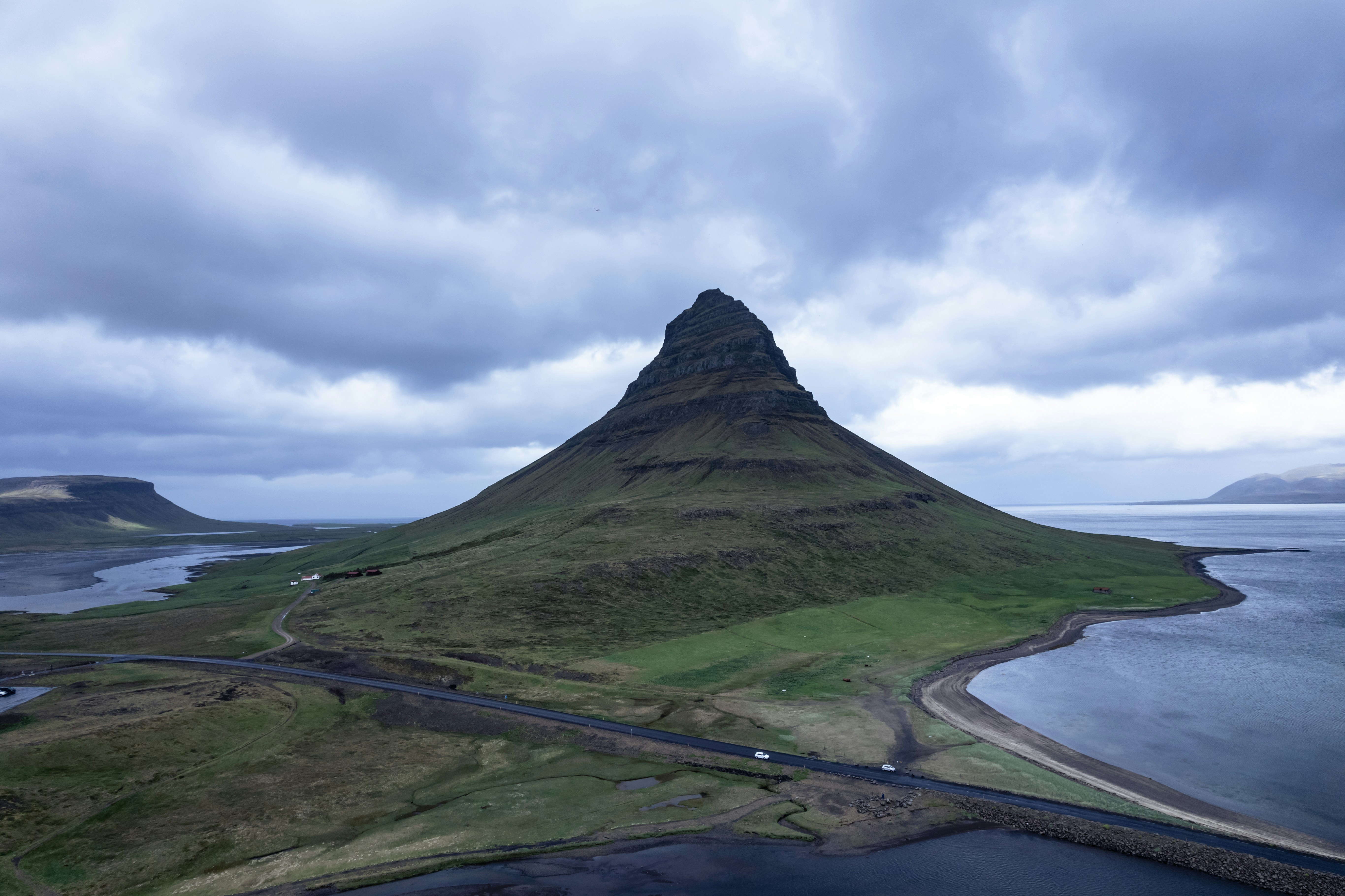 An aerial view of a mountain and a body of water