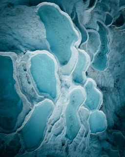 A close up of a rock formation with ice on it