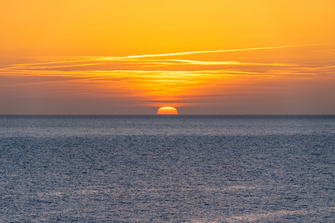 The sun is setting over the ocean on a clear day, Sunset in Menorca