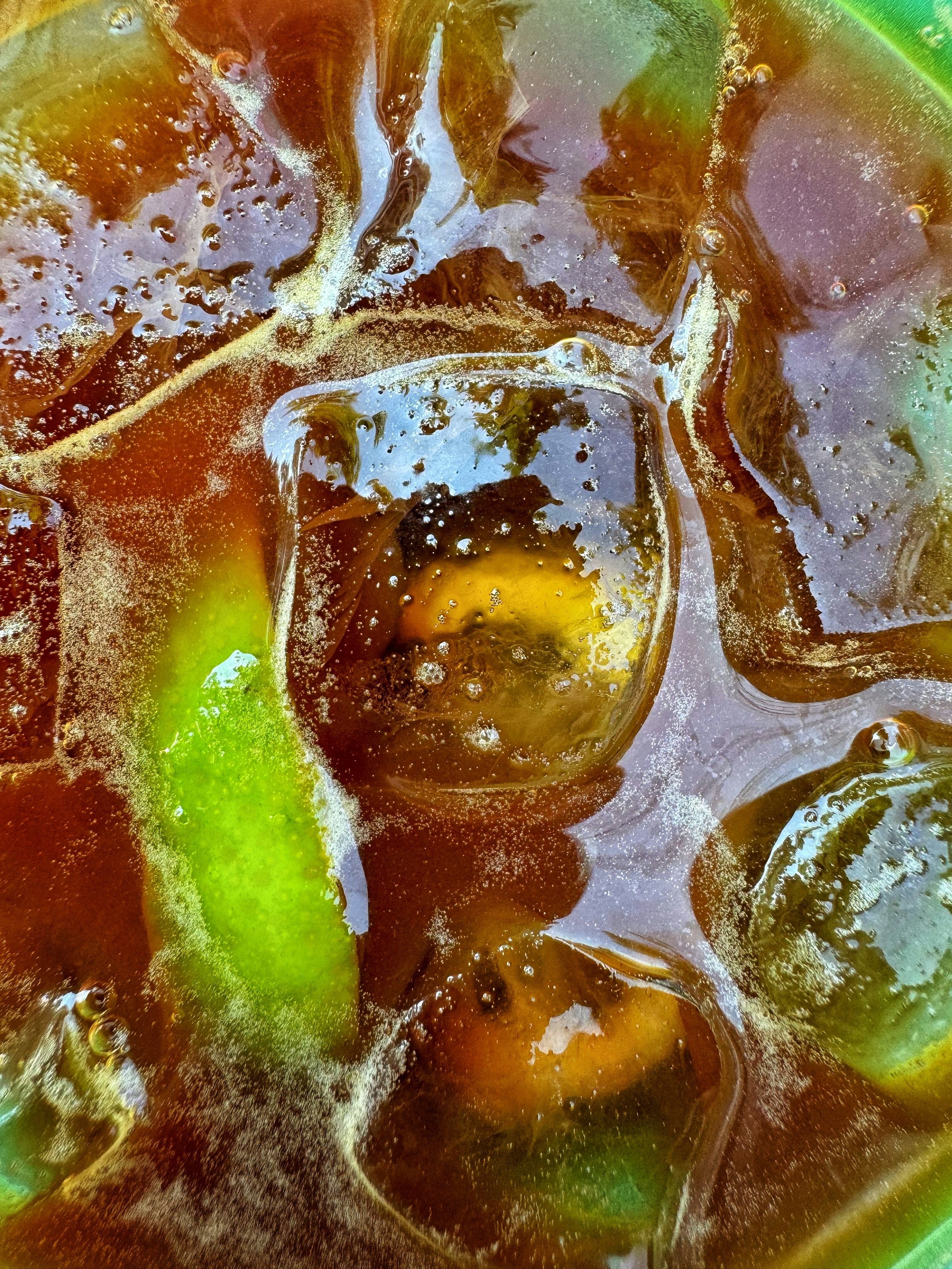 A green bowl filled with ice and fruit