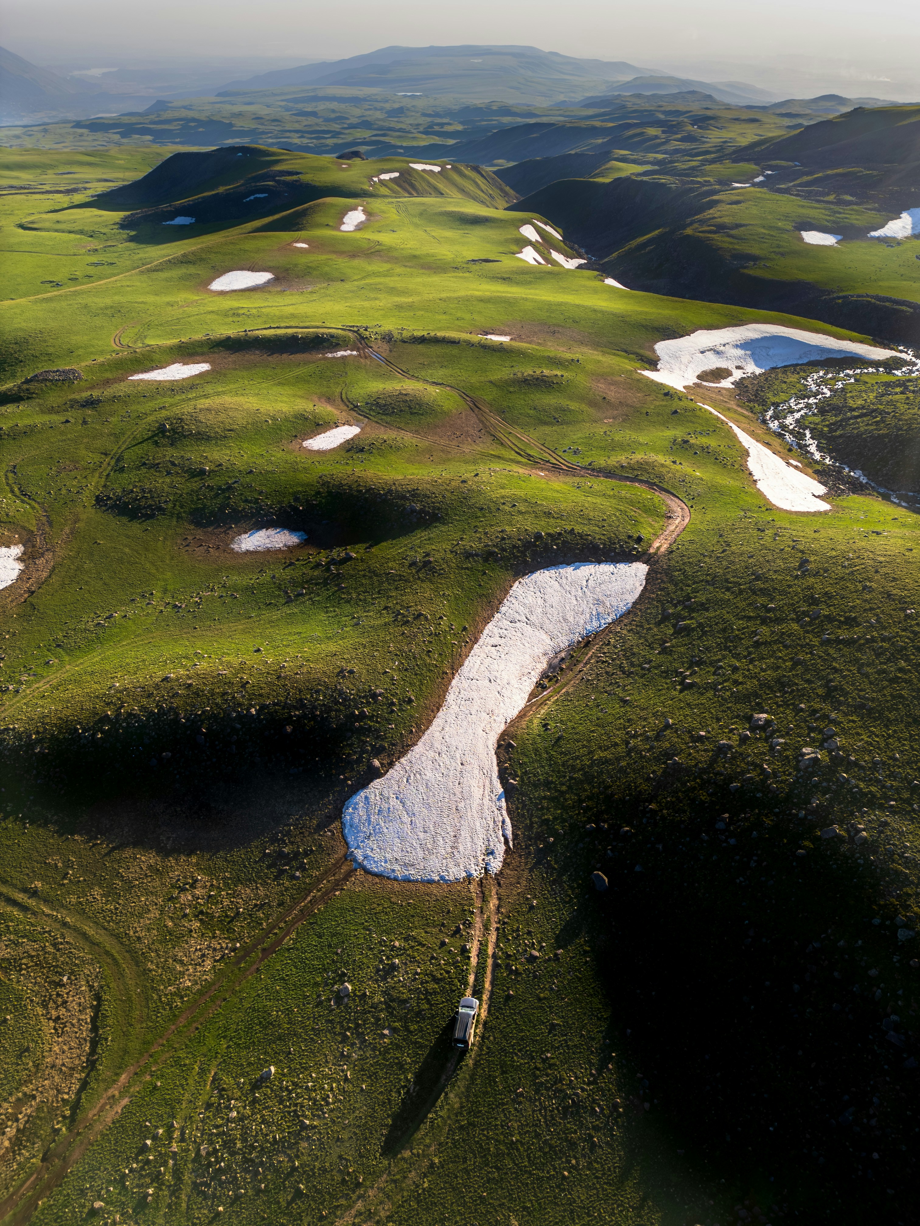 An aerial view of a golf course in the mountains