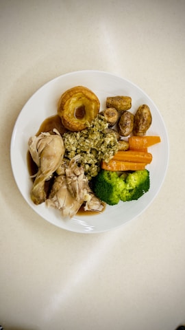 A white plate topped with different types of food