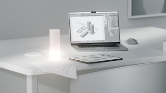 A laptop computer sitting on top of a white desk