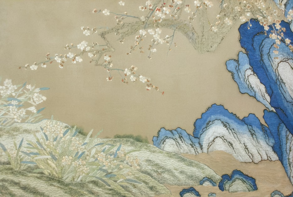 Delicate white blossoms on branches above blue rocks and grass — a study in the restrained chromatic sophistication of classical Chinese botanical painting that informs the bag's design vocabulary.