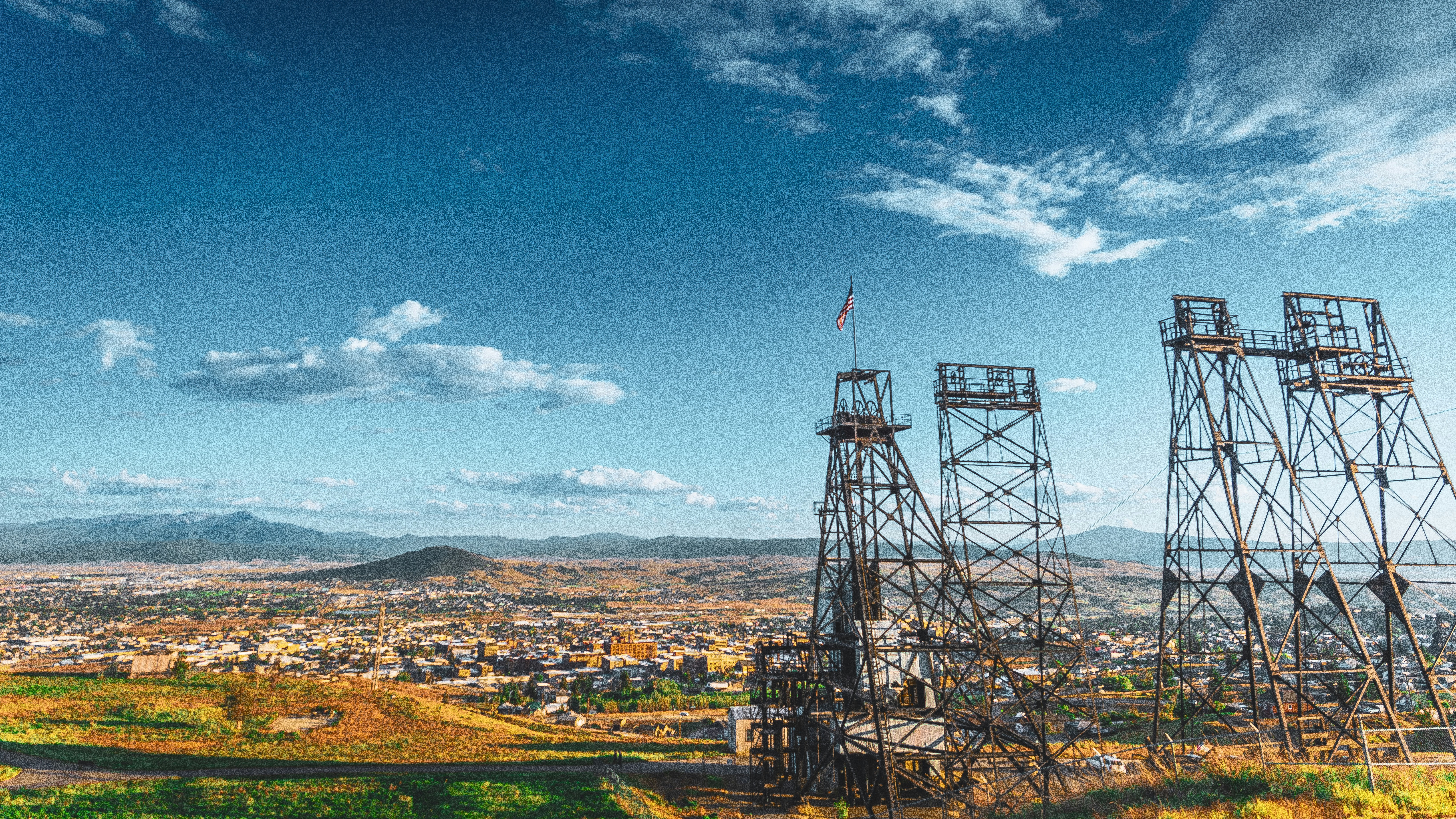An aerial view of a city with power lines in the foreground