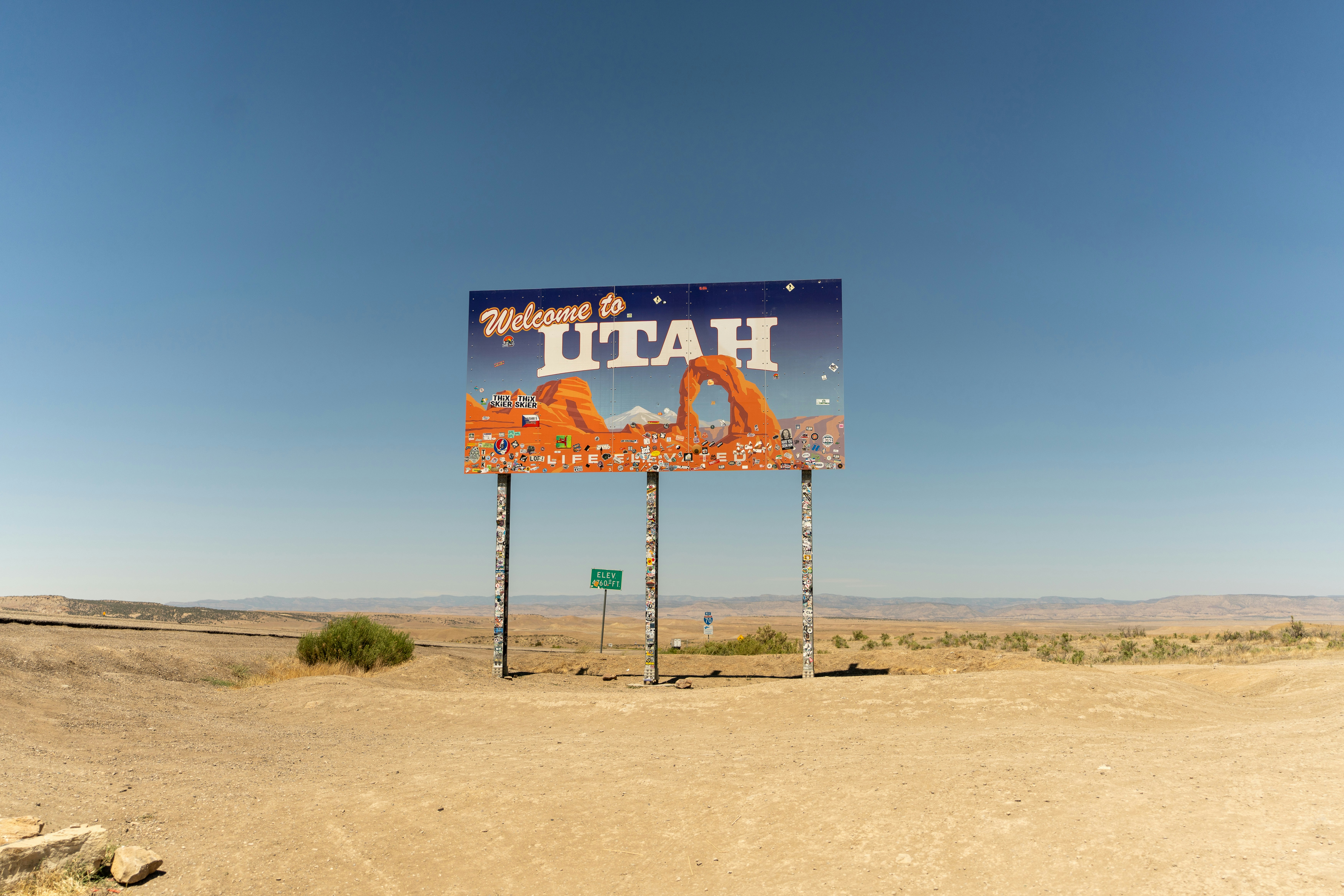 A large sign in the middle of a desert