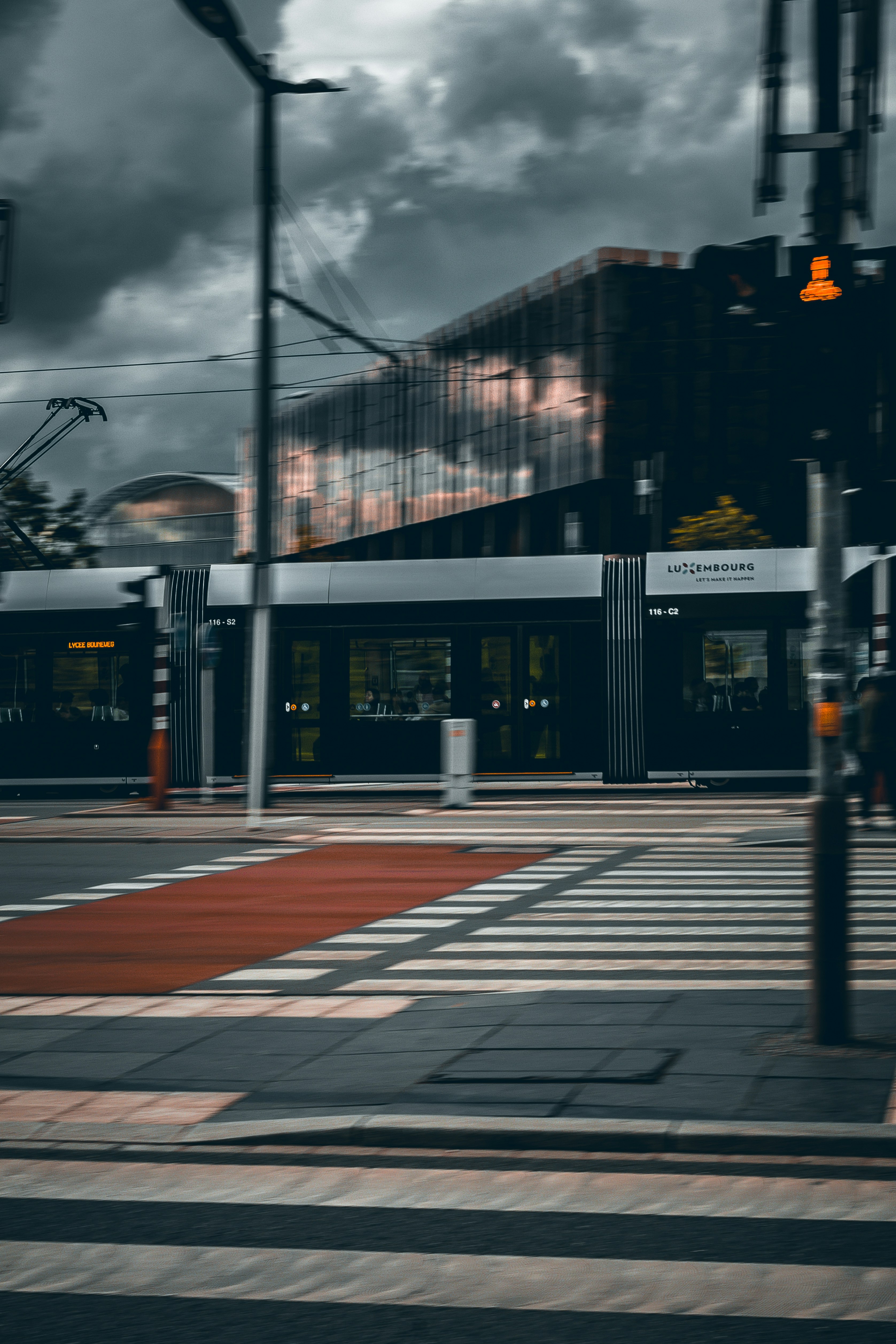 A city street with a traffic light and a building in the background ...