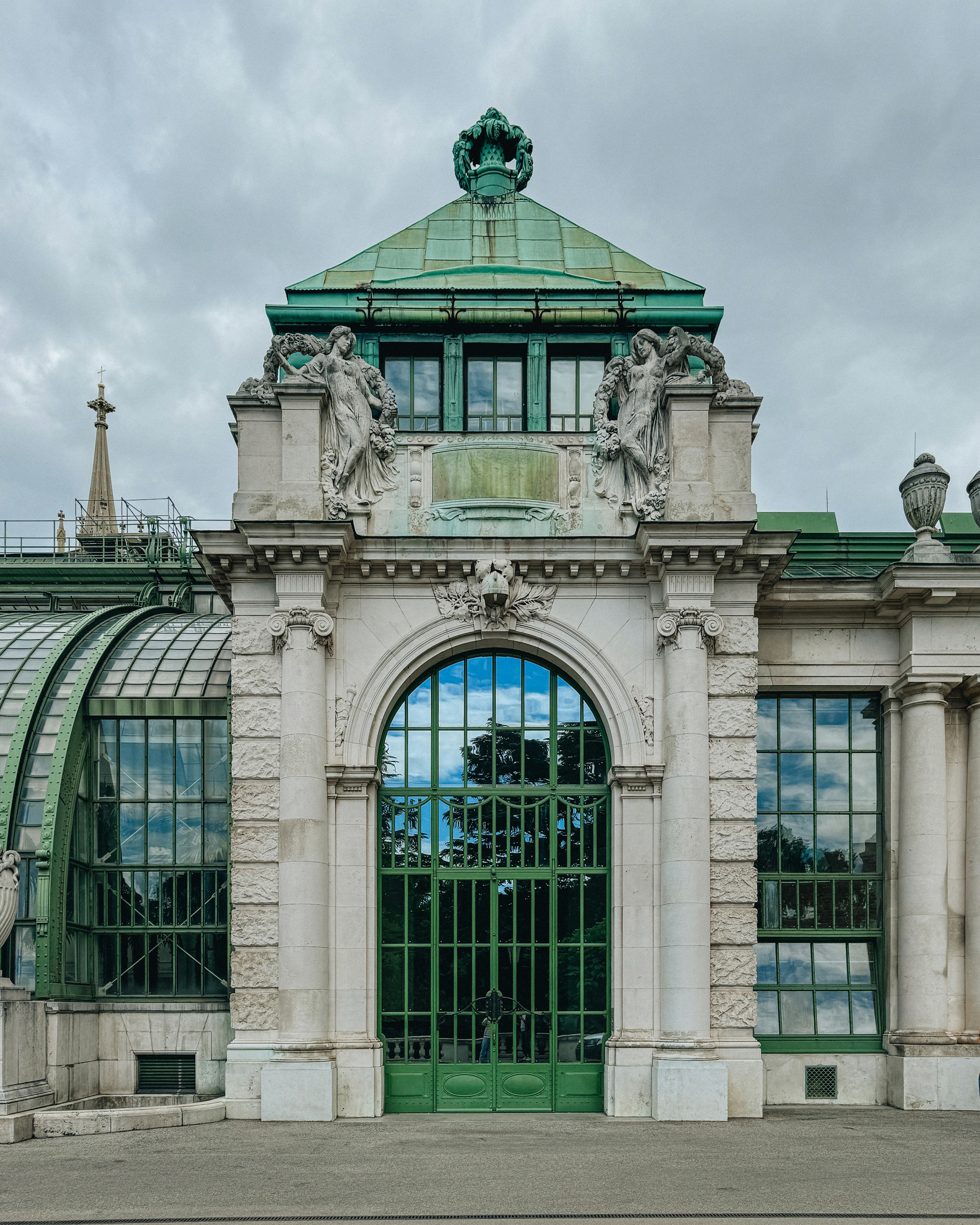A green and white building with a green door