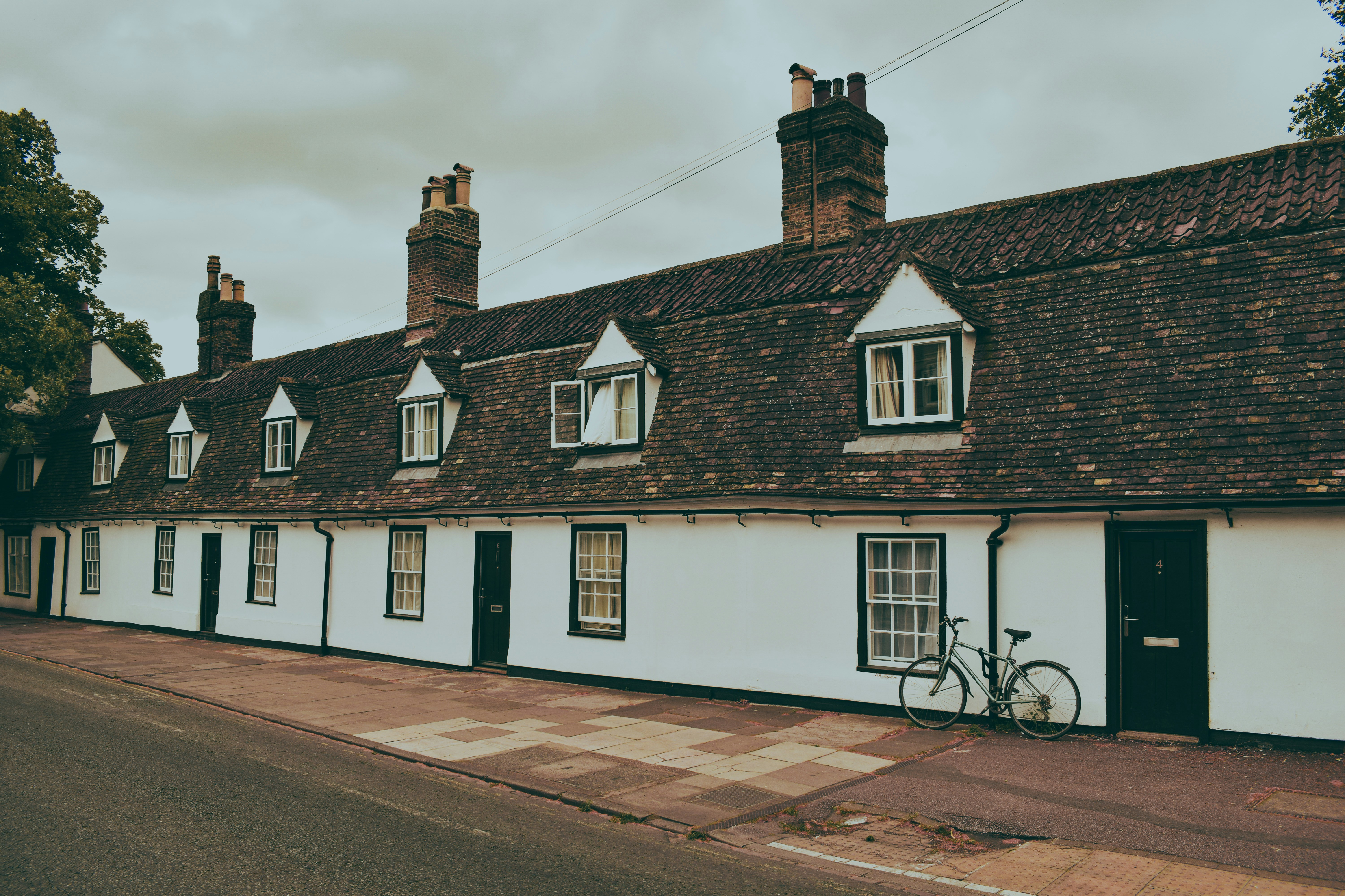 A row of white houses sitting on the side of a road