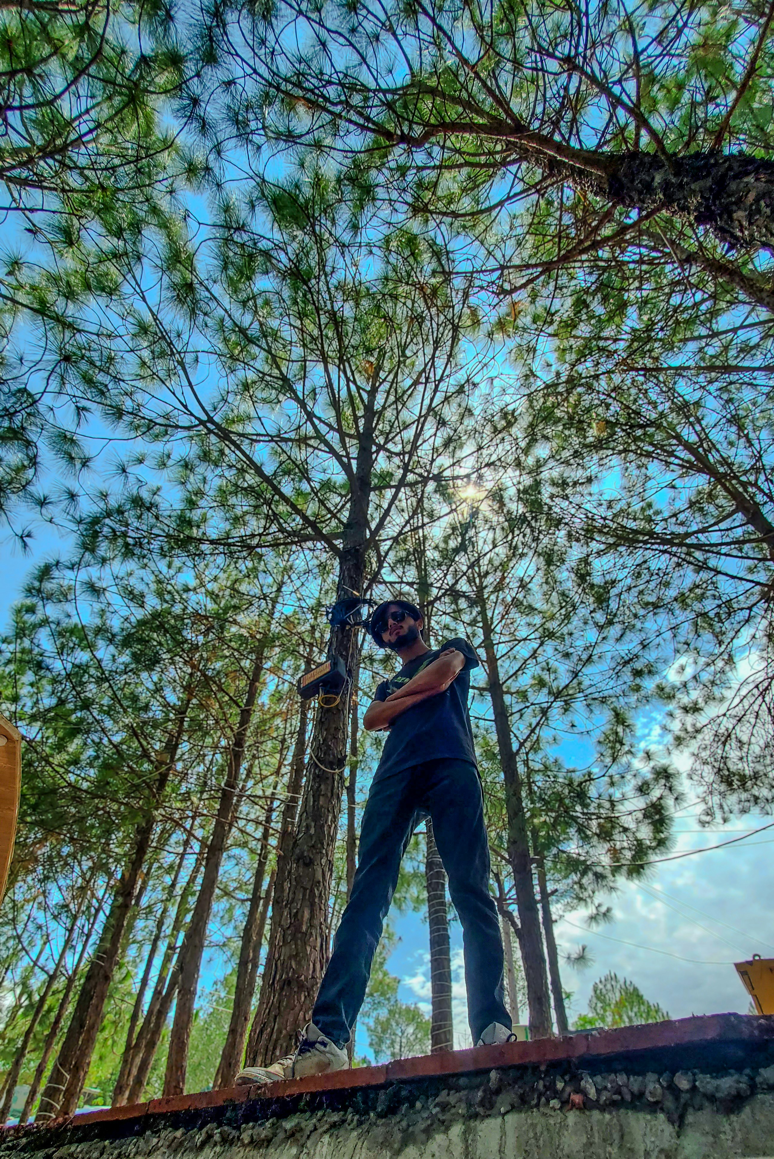 A man standing on top of a wooden bridge