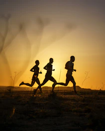 A couple of people that are running in the dirt