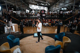 A man standing on a stage in front of a crowd