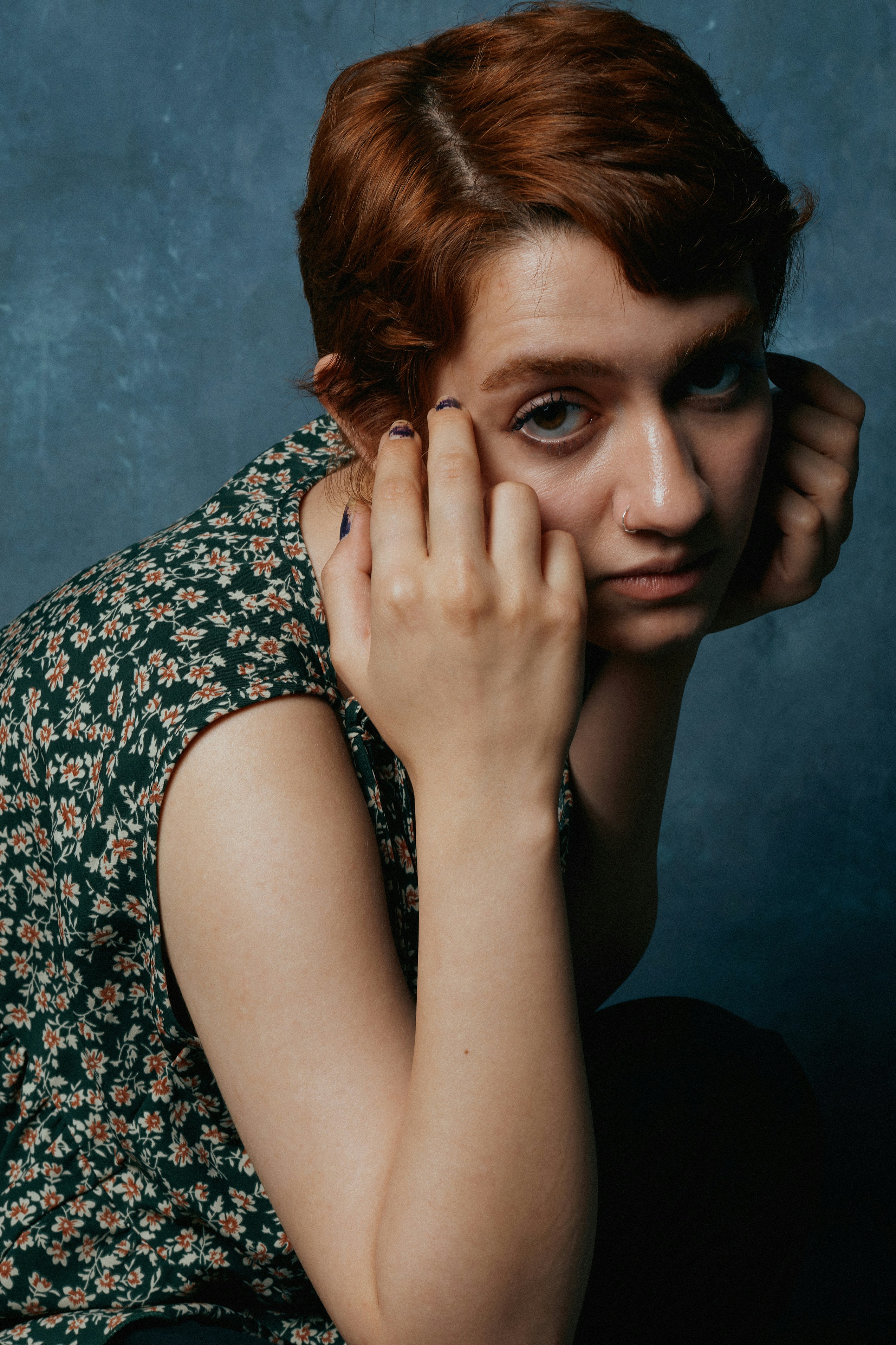 Woman looking thoughtfully out a window, a subtle cyclical pattern overlaid on the scene, representing hidden mood rhythms.