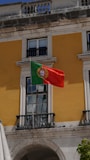 A flag flying in front of a building