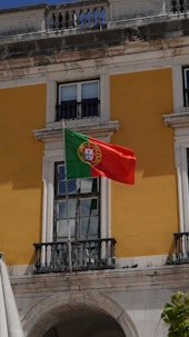 A flag flying in front of a building