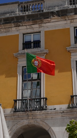 A flag flying in front of a building