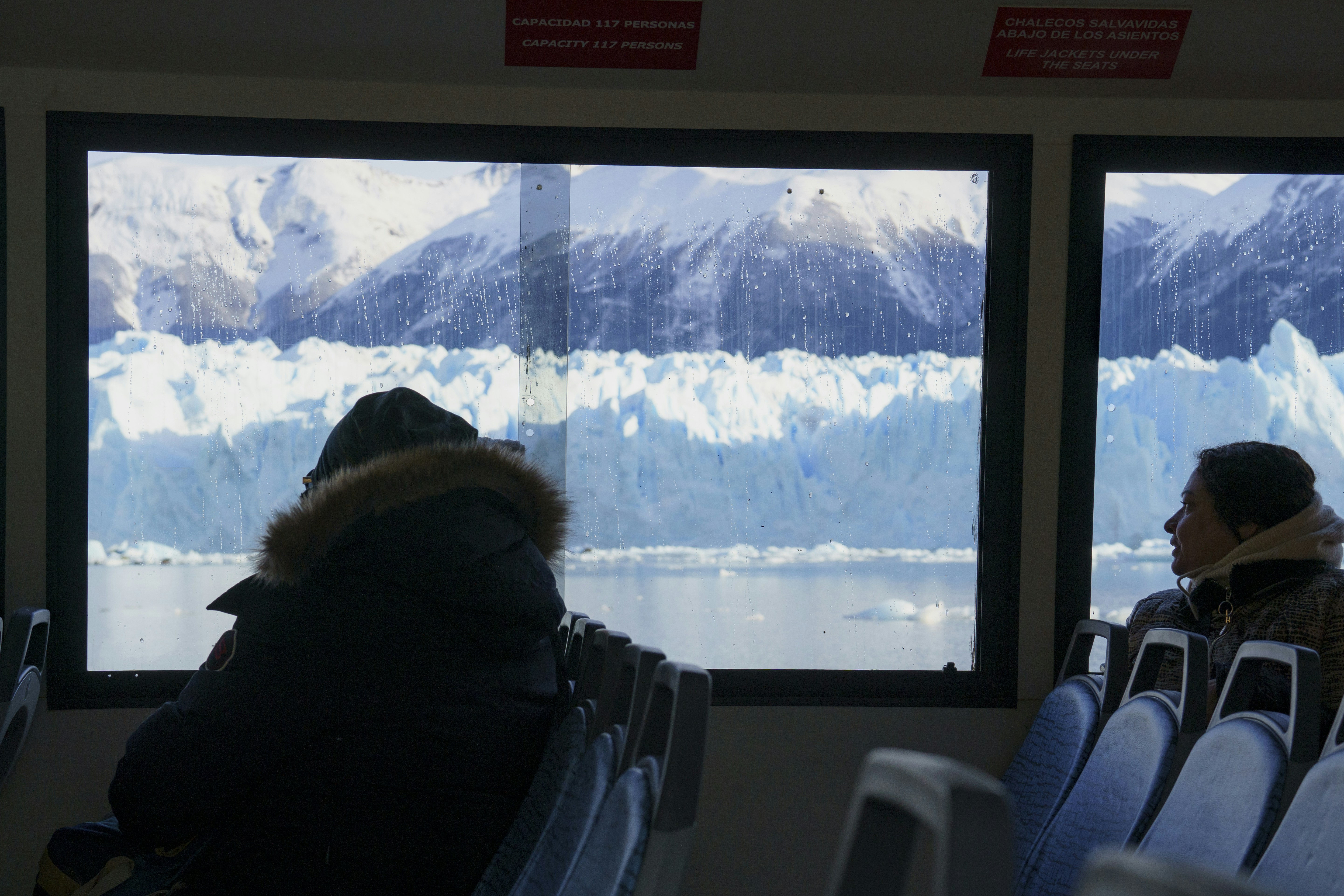 A couple of people that are sitting in a bus, 