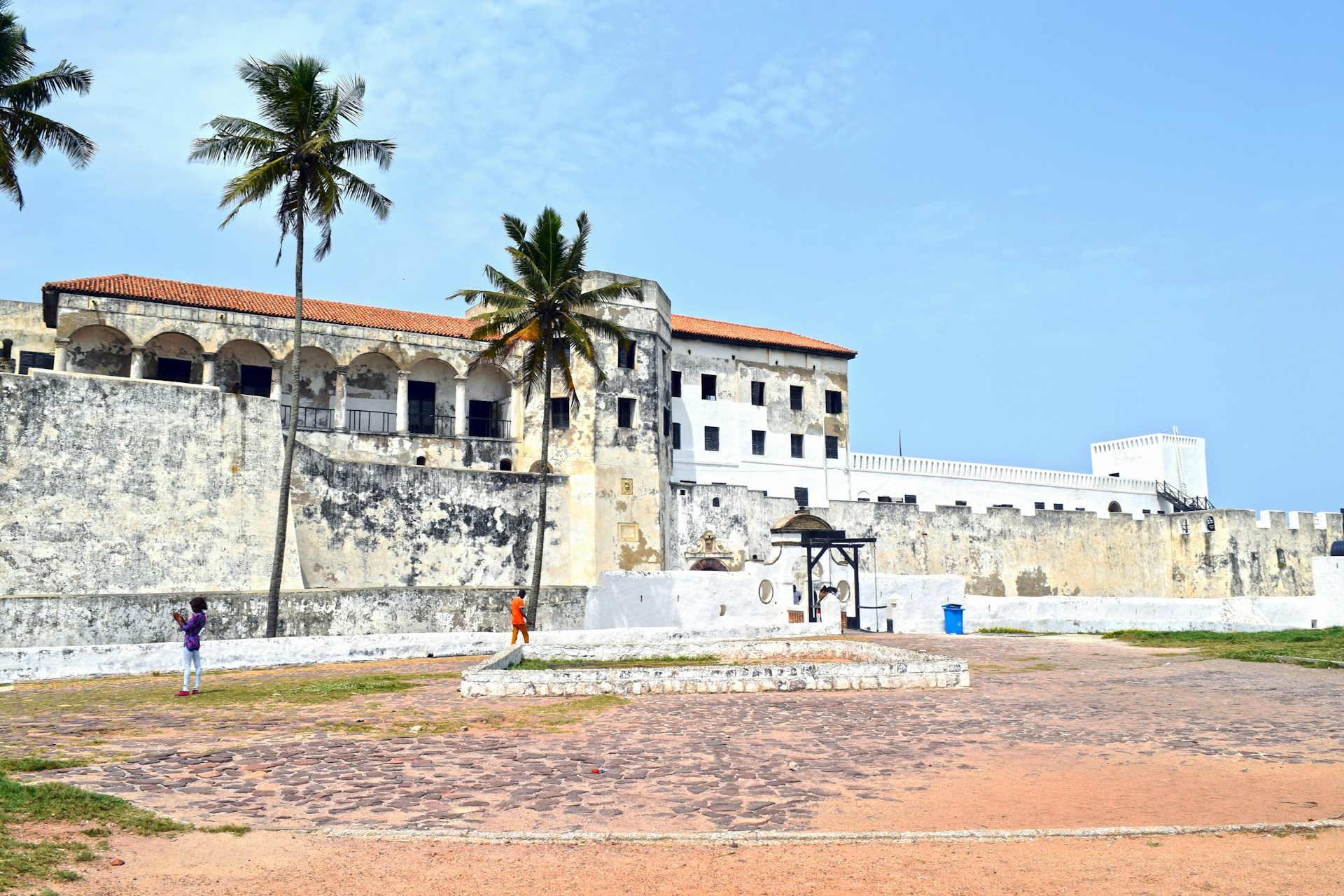 A large building with palm trees in front of it