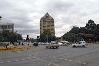 A city street filled with lots of traffic next to tall buildings